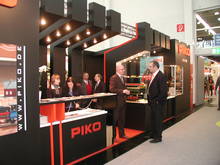 Domestic Sales Manager, Mr. Jens Beyer, in conversation with a customer's booth at the entrance to PIKO